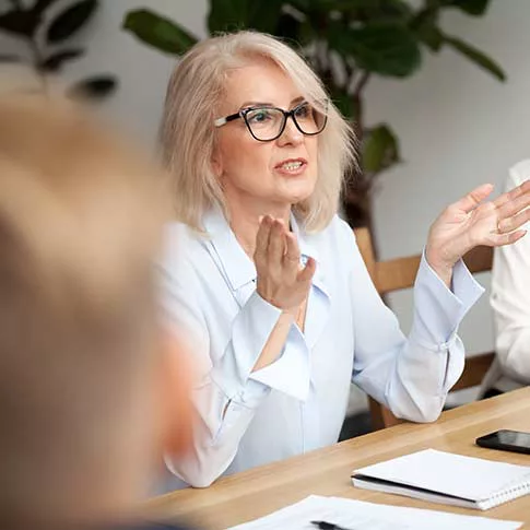 The female leader is giving directions to her employees