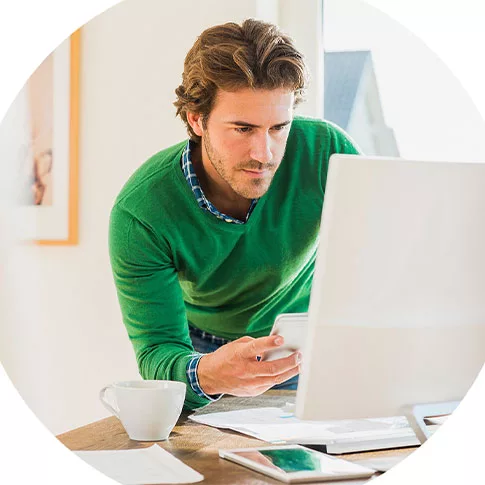 a man is seriously doing his work in front of the computer