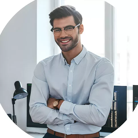 worker stands and smiles at the camera